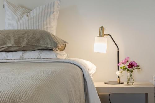 a bedroom with a bed and a table with a lamp at Puna BnB in Matamata