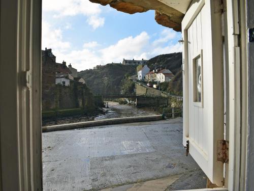 an open door with a view of a street at The Anchorage in Staithes