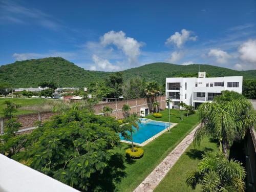 a view of a resort with a swimming pool and mountains at La Casa Blanca VIP in Tlayecac