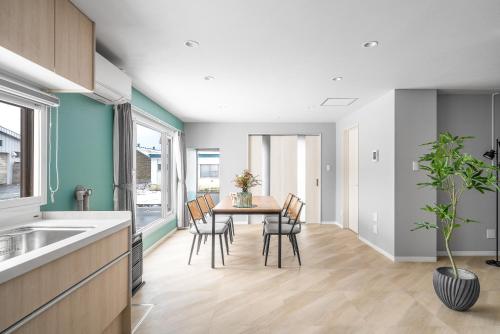 a kitchen and dining room with a table and chairs at Villas Park Kamifurano in Kami-furano