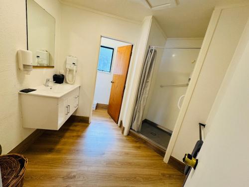 a bathroom with a sink and a shower at Chelmswood Motel Taupo in Taupo