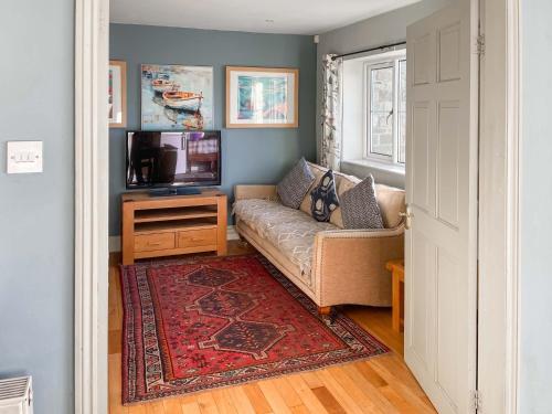 a living room with a couch and a television at York House in Richmond