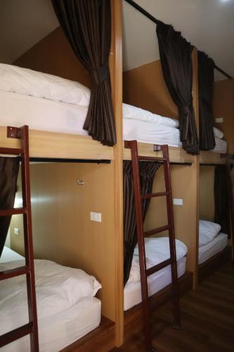 a group of bunk beds in a room at HOM's HOSTEL in Phuket