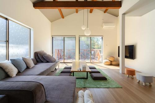 a living room with a couch and a table at NODOKA Awajishima in Minamiawaji