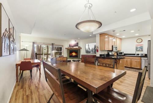 a kitchen and dining room with a wooden table and chairs at 2 Miles to Palisades Ski Resort w Free Shuttle! in Olympic Valley