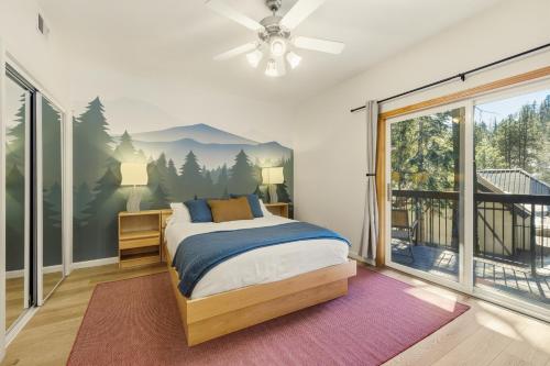 a bedroom with a bed with a mountain mural on the wall at 2 Miles to Palisades Ski Resort w Free Shuttle! in Olympic Valley