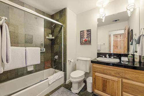 a bathroom with a toilet and a tub and a sink at 2 Miles to Palisades Ski Resort w Free Shuttle! in Olympic Valley