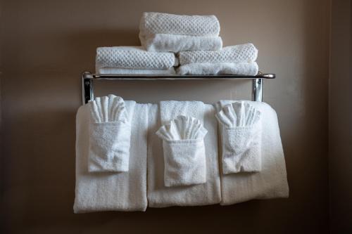 a group of white towels on a towel rack at Quality Inn & Suites Santa Maria in Santa Maria