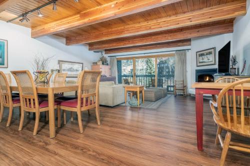 a dining room and living room with a table and chairs at Riverside Condos D02 condo in Telluride