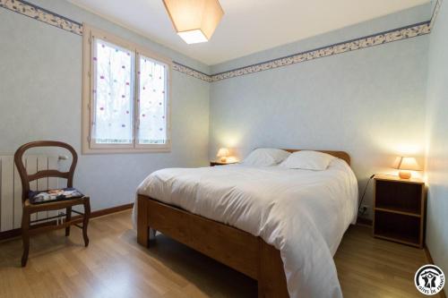 a bedroom with a large bed and a window at Farguettou in Nailloux