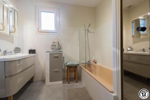 a bathroom with a tub and a sink and a shower at Farguettou in Nailloux