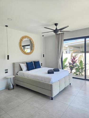 a bedroom with a bed and a ceiling fan at Villa Mona in Nathon Bay