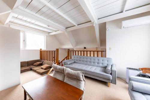 a living room with a couch and a table at niseko / Vacation STAY 4376 in Niseko