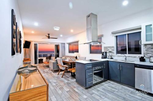 a kitchen and dining room with a dining table at Gated Community Oceanview Condo Pool & Gym in La Paz