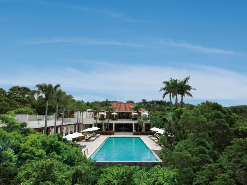 an aerial view of a house with a swimming pool at The Atta Terrace Club Towers in Onna