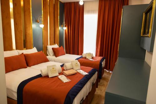 a hotel room with two beds with certificates on them at crown taksim hotel in Istanbul