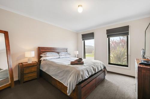 a bedroom with a bed with a teddy bear laying on it at Paradise Point Cowes in Cowes