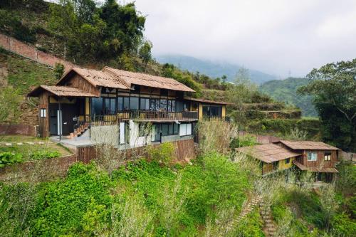 a group of houses on a hill at Sapana Mountain Retreat in Sapa