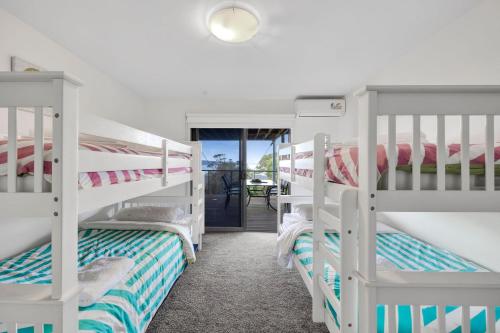 a room with three bunk beds in a room at Scelta in Lorne