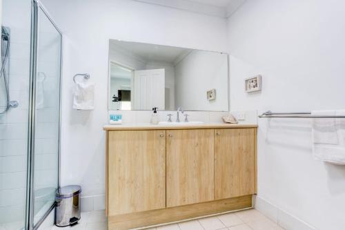 a bathroom with a sink and a shower at Relax at 42 Cape View Resort in Broadwater