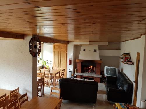 a living room with a couch and a fireplace at Hostel Bovec in Bovec