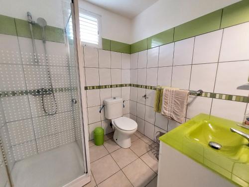 a bathroom with a shower and a toilet and a sink at La créola BAYALOCATION in Rivière-Pilote