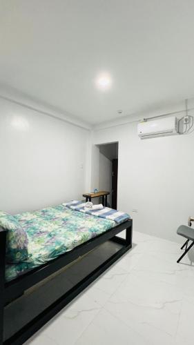 a bedroom with a bed in a white room at Belga Boarding House in Guimaras