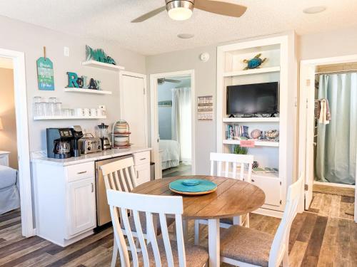 a kitchen and dining room with a table and chairs at North Cape- Behing Trading Post - Pet Friendly in Cape San Blas