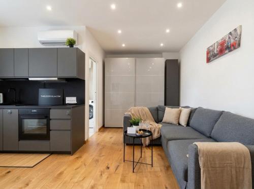 a living room with a couch and a kitchen at Sparano Mood 170 in Bari