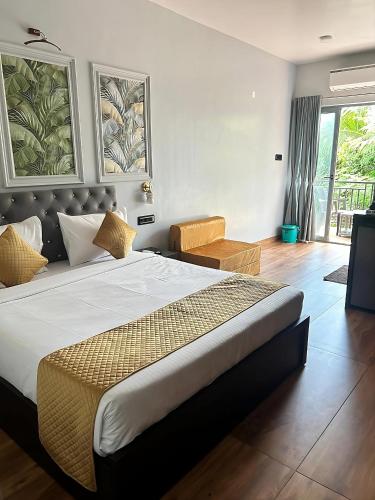 a bedroom with a large bed in a room at La Sea Vue Goa in Goa