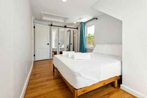 a bedroom with a white bed and a window at Tog Gun R&R I in Norfolk