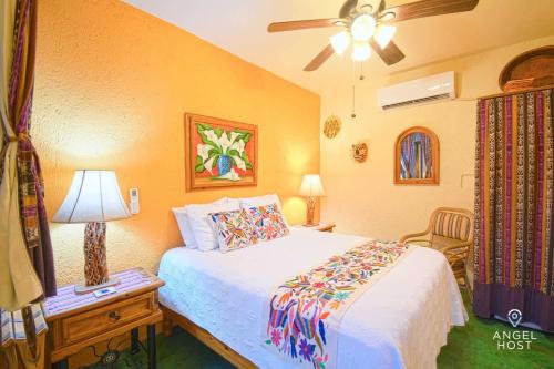 a bedroom with a bed and a ceiling fan at Beachside Bliss Suite 1 Block from Malecon in La Paz