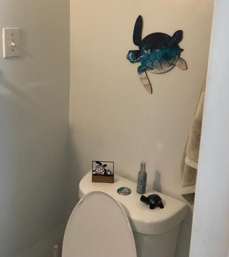 a bathroom with a toilet with a fish on the wall at Tropical Oasis in Christiansted