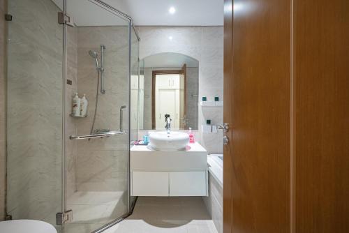 a bathroom with a sink and a shower at Elysian Suites In Landmark Saigon by VNS in Ho Chi Minh City