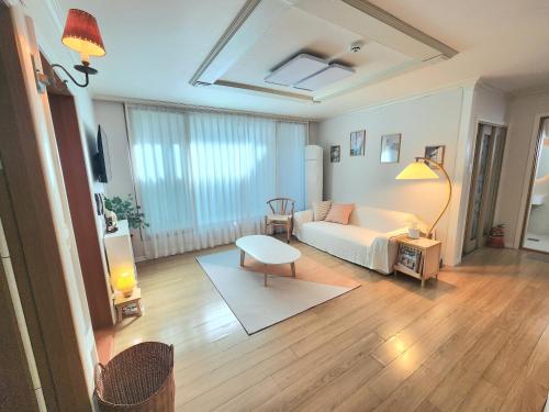 a living room with a couch and a table at 상무하우스 in Gwangju