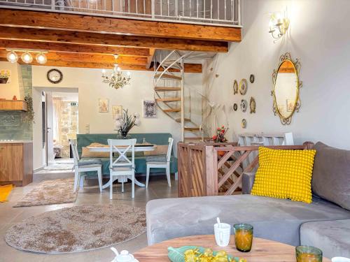 a living room with a couch and a table at Muses Mountain View in Ayía Varvára