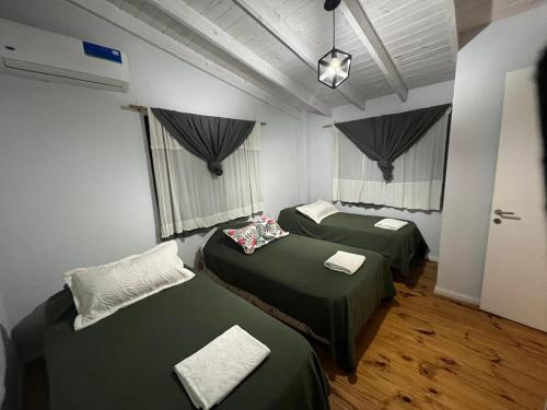 a room with two green beds in it at Monica’s Apartments in Canning