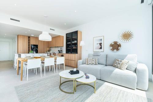 a living room and kitchen with a couch and a table at Edelweiss in Los Alcázares