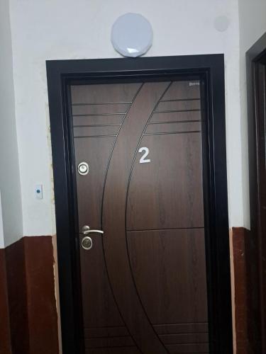 a wooden door with the number two on it at Удобство - 3 in Petrich