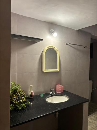 a bathroom with a sink and a mirror at Untitled Space Residency in Bangalore