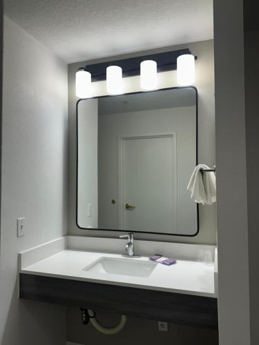 a bathroom with a sink and a large mirror at Quality Inn Carlin in Carlin