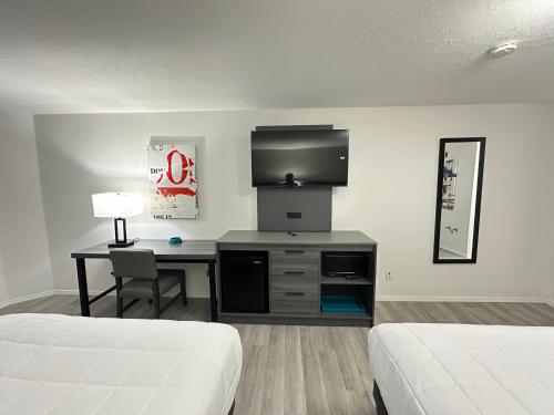 a hotel room with a desk and a television at Quality Inn Carlin in Carlin