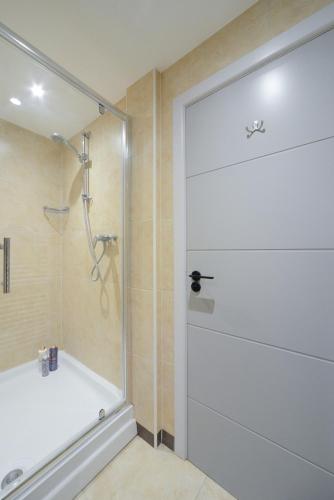 a shower with a glass door in a bathroom at Beautiful Apartment near Bournemouth, Poole & Sandbanks in Poole