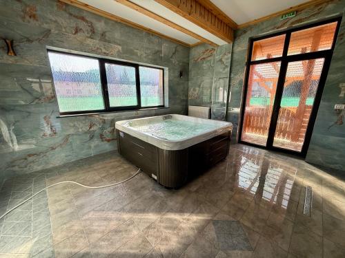 a large bathroom with a bath tub in a room at Vila Arina -Private Retreat in Voronet