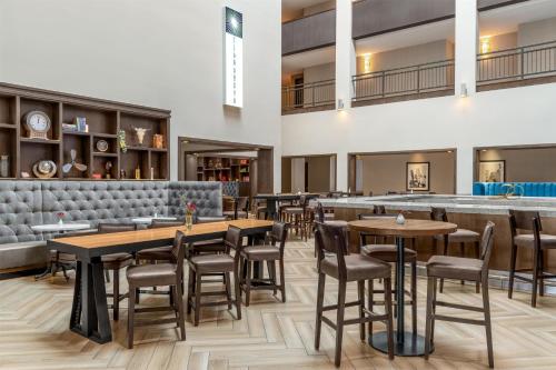 a restaurant with tables and chairs and a bar at Doubletree By Hilton Lubbock - University Area in Lubbock
