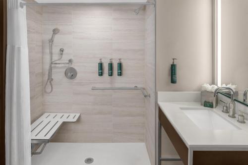 a white bathroom with a shower and a sink at Doubletree By Hilton Lubbock - University Area in Lubbock