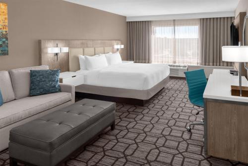 a hotel room with a bed and a couch at Doubletree By Hilton Lubbock - University Area in Lubbock