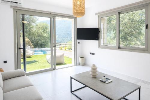 a living room with a couch and a table at Saint Helen Villas in Parga