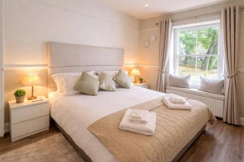 a bedroom with a large bed with two towels on it at Corbridge Apartment in Corbridge