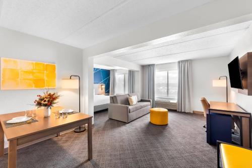 a hotel room with a desk and a living room at Comfort Suites Austin Airport in Austin